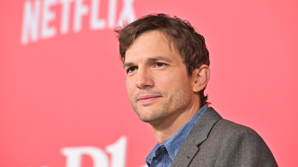 Ashton Kutcher at a tech event representing his business success